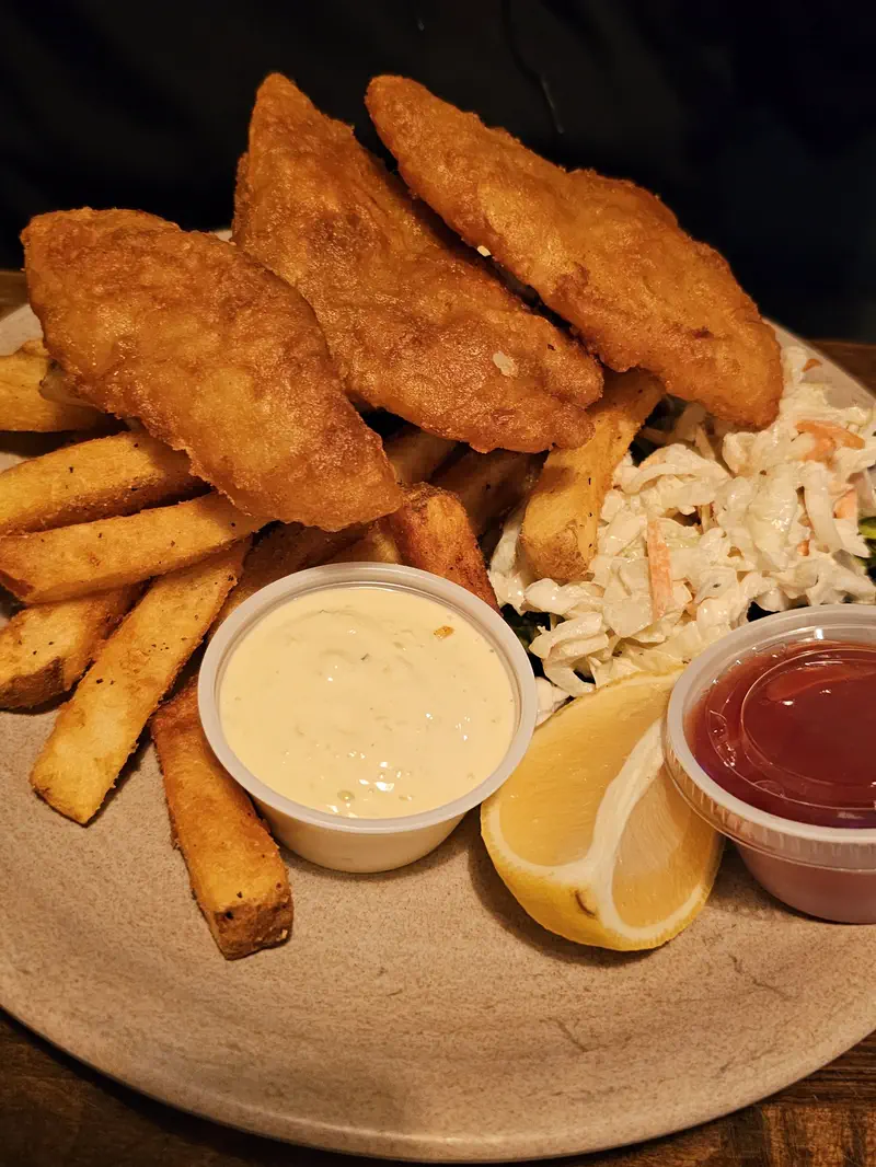 Fish and chips with fries, slaw, tartar sauce and lemon